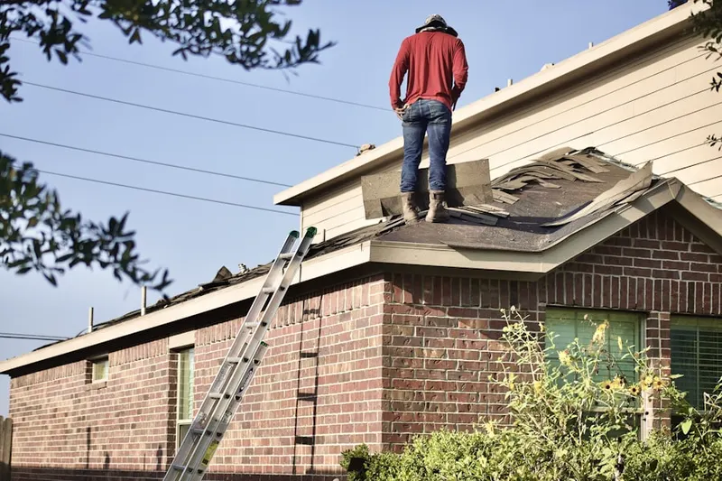 Professional roofer working on a residential roof in Wilkins